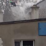 Dron badający stężenia pyłu zawieszonego nad budynkiem.