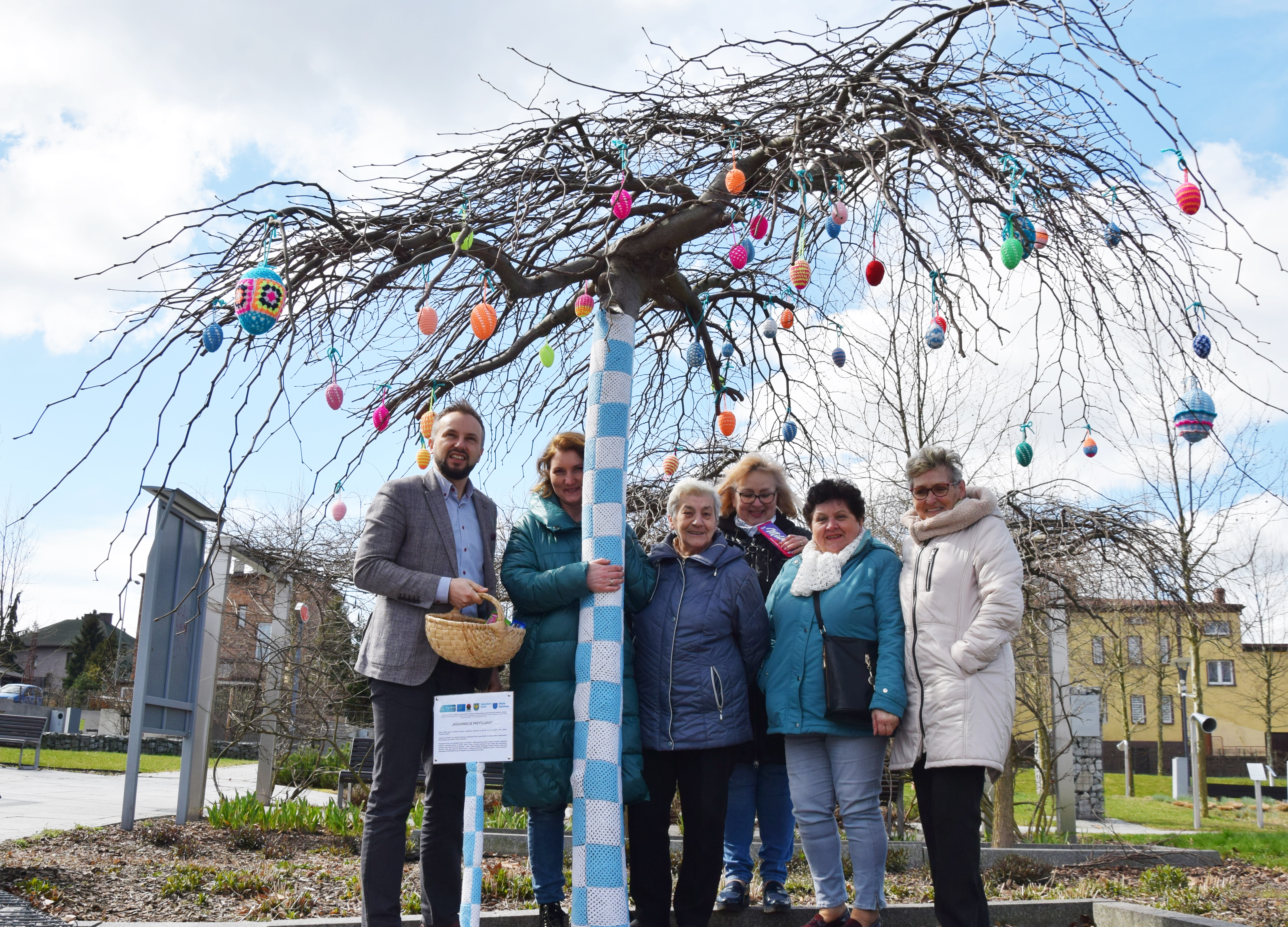 Patchwork authors under a decorated tree.
