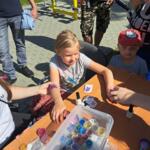 Children playing at the eco-manager's stand.