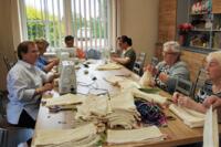 Women from the Senior Club sewing eco-friendly bags.