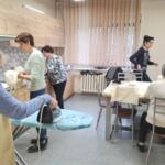 Women from the Senior Club sewing eco-friendly bags. 