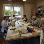 Women from the Senior Club sewing eco-friendly bags. 