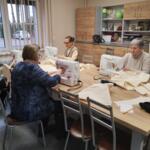 Women from the Senior Club sewing eco-friendly bags. 