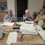 Women from the Senior Club sewing eco-friendly bags. 