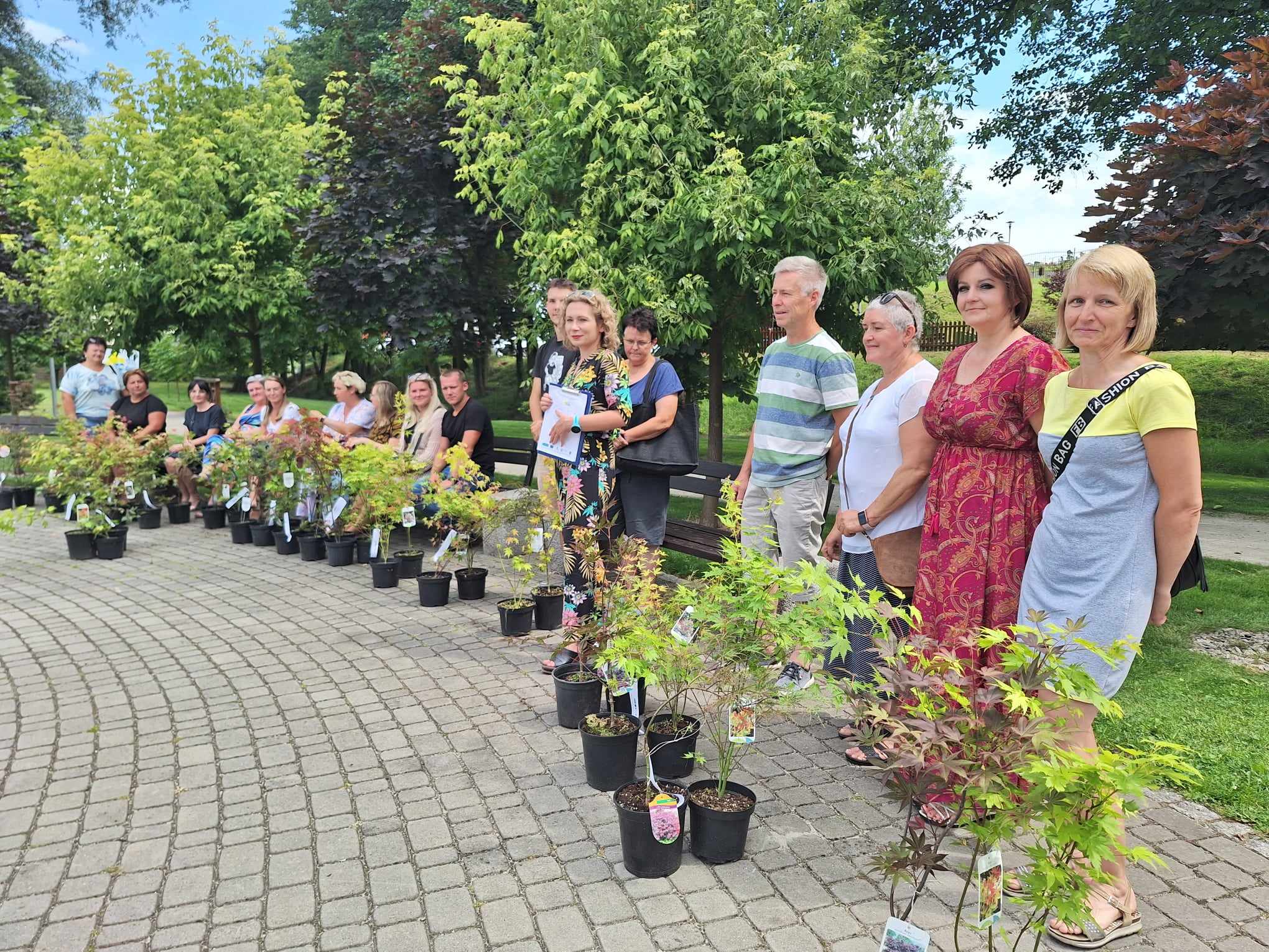 Winners of the competition with the eco-manager and young maple seedlings.