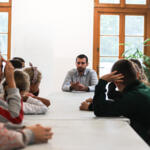 An eco-manager with a group of children conducting physical experiments.