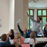 An eco-manager with a group of children conducting physical experiments.
