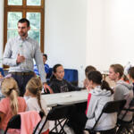 An eco-manager with a group of children conducting physical experiments.