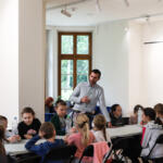 An eco-manager with a group of children conducting physical experiments.