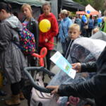 In front of the tent, a group of participants.