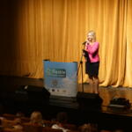 Eco-manager Paulina Podsiadło conducting a presentation on the stage.