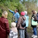 Participants on the walk listening to the guide talking about the plants.