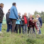 Participants on the walk listening to the guide talking about the plants.