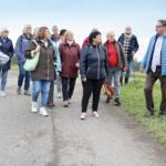 Participants on the walk listening to the guide talking about the plants.