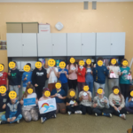 A group of participants holding certificates of participation.