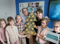 A group of children presenting eco-friendly Christmas decorations.