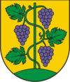 Herb Gminy Zbrosławice przedstawiający krzew winorośli oplatajacy tyczkę